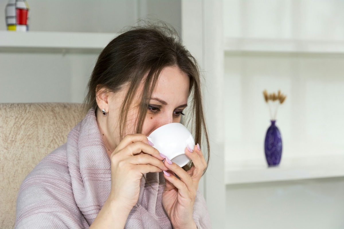 A sick woman drink tea