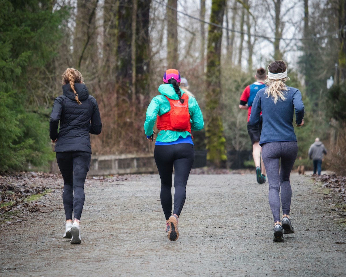 Group of men and women jogging in winter