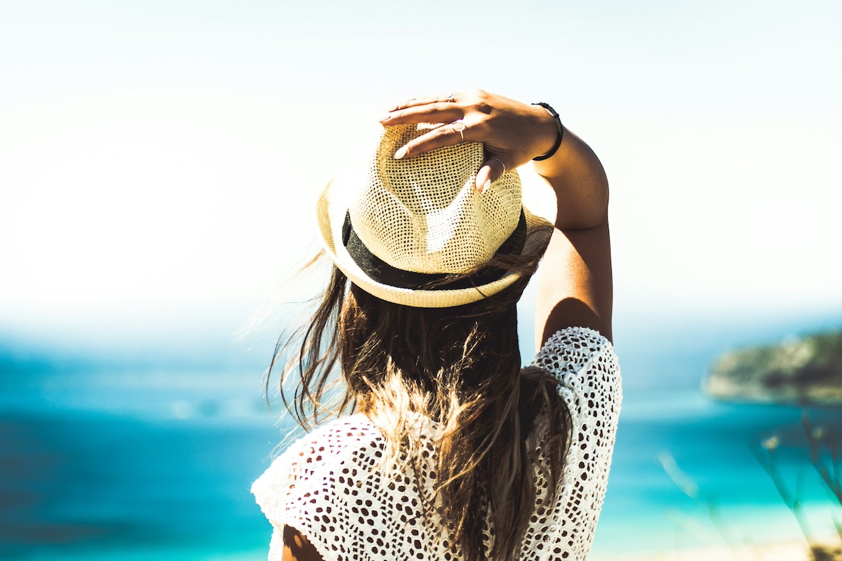 Woman wearing a straw hat at the beach